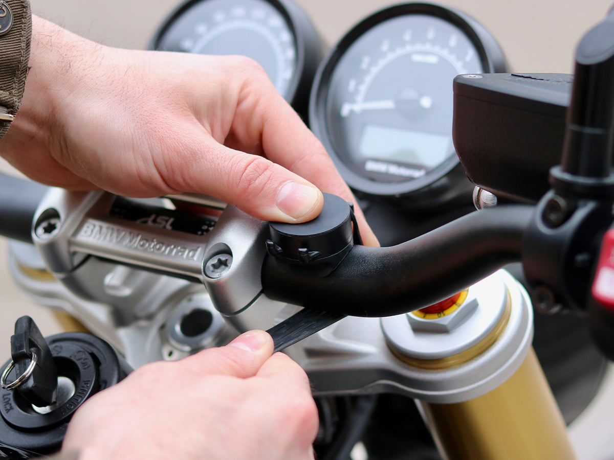 The Shapeheart bike Handlebar smartphone mount attaches with a silicone strap to motorcycle handlebars from 20 to 30mm in diameter